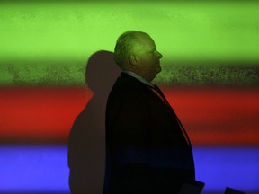 Mayor Rob Ford walks in front of a projector screen at a Toronto City Council executive committee meeting to discuss the 2014 budget at City Hall on January 22, 2014. (MICHAEL PEAKE/TORONTO SUN)