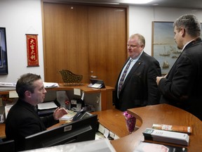 Toronto Mayor Rob Ford talks to his receptionist before leaving his office just after 3pm on Thursday January 23, 2014. (Michael Peake/QMI Agency)