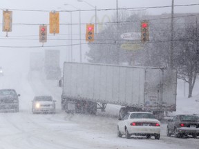 Local police are urging residents to stay off the roads. Collisions continue to occur on local and regional roads including on Highway 401. Blowing snow is creating whiteout conditions in many areas. Here, a tractor-trailer tries to maneuver its way onto North Front Street. 
Emily Mountney/The Intelligencer