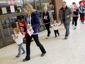 Jenna Coe of Marmora and her daughters Sydney and Avery, along with her mother Betty-Anne Duguid and father Jim, take part in Belleville's Walk for Memories organized by the Alzheimer Society of Belleville-Hastings-Quinte, Sunday, Jan. 26, 2014 at the Bay View Mall. 
Emily Mountney/The Intelligencer/QMI Agency