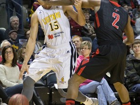 Garrett Williamson of the London Lightning knocks over Brent Jennings of the Brampton A?s while going to the net Sunday during the Lightnings? 114-108 win at Budweiser Gardens. It was a game the Lightning had to win to stay in the hunt and they came from a 15-point third-quarter deficit to do it. (DEREK RUTTAN, The London Free Press)