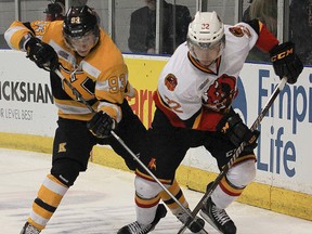Belleville Bulls defenceman Mark Raycroft battles for the puck with Kingston Frontenacs forward Sam Bennett during OHL action Sunday in Kingston. (JULIA McKAY/The Whig Standard)
