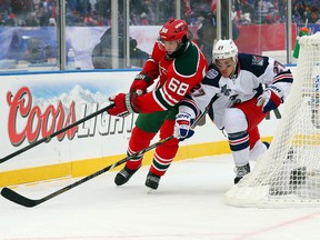 New Jersey Devils right wing Jaromir Jagr skates after the puck against New York Rangers defenceman Ryan McDonagh at Yankee Stadium in New York, Jan. 26, 2014. (ED MULHOLLAND/USA Today)