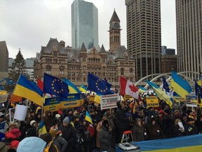 Protesters converged on Toronto City Hall Sunday to urge the Canadian government to impose sanctions on Ukraine. (MARYAM SHAH, Toronto Sun)