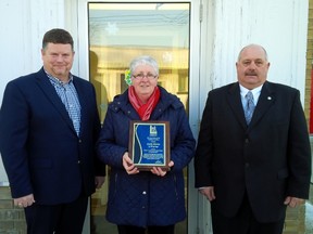 Lambton County Warden Todd Case, left, presents his Citizen of the Month award to Oil Springs resident Cathy Martin. They are joined by Oil Springs Mayor Ian Veen. SUBMITTED PHOTO