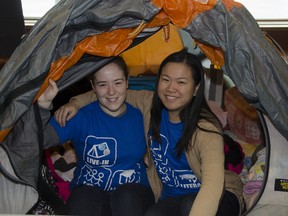 Queen's University students Emily Fahlgren (left) and Amelia Zheng will be living in a tent in the atrium of the Joseph S. Stauffer Library from Jan. 24 to 31 to help raise awareness and funds for the Live-In for Literacy campaign. JULIA MCKAY/The Whig-Standard