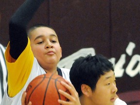 Richard Kim, right, of the Indian Creek Road Sun Devils is guarded by Dante St. Pierre of the Windsor General Brock Bulldogs during the championship game in the first Dave Allin Classic elementary school boys basketball tournament Saturday at McGregor. Brock won the final 64-42. Tournament all-stars Alec McGregor and Connor Goldsmith scored 29 and eight points, respectively, for the Sun Devils. All-star Brandon Tatsu led Gregory Drive to third place in the 15-team tournament. Queen Elizabeth II won the consolation final. Tournament proceeds will go to the Windsor-Essex County ALS Society. (MARK MALONE/The Daily News)