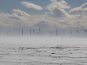 The wind turbines on Wolfe Island are partially obscured by blowing snow during a cold and windy winter day in Kingston on Monday.
IAN MACALPINE/KINGSTON WHIG-STANDARD/QMI AGENCY