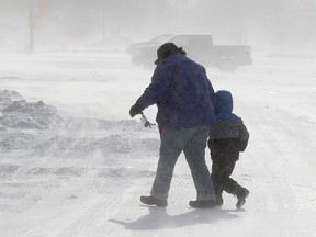 Shoppers make their way through blowing snow in the Polo Park parking lot in Winnipeg, Man. Sunday January 26, 2014. (Brian Donogh/Winnipeg Sun/QMI Agency)