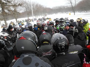 Snowmobilers gather around local officials as they talk about the recent decision by the St. Lawrence Parks Commission to ban snowmobiles from the Thousand Islands Parkway.