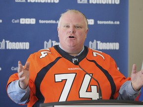 Toronto Mayor Rob Ford, wearing a Broncos jersey with the number of Torontonian Orlando Franklin, speaks to the media about the budget Monday, January 27, 2014. (Stan Behal/Toronto Sun)
