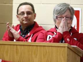 An emotional Heidi Duhamel finishes reading a passage from her daughter Meagan's journal, as her husband Danny looks on at the Walden Arena last night.