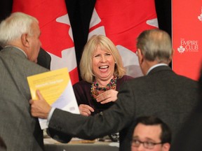 Ontario Minister of Health Deb Matthews laughs with former Ontario premier David Peterson (left) and another invited guest to the Empire Club of Canada in Toronto on Monday January 27, 2014. (Stan Behal/Toronto Sun)