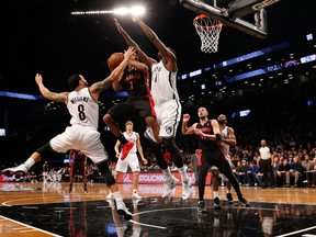 Nets point guard Deron Williams and centre Andray Blatche go up with Raptors point guard Kyle Lowry in Brooklyn last night. (USA TODAY/PHOTO)