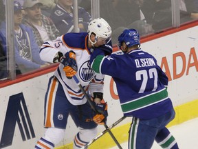 Martin Marincin battles for the puck with Canucks’ forwardc Daniel Sedin during the first period of Monday’s game in Vancouver. (Codie McLachlan, Edmonton Sun)