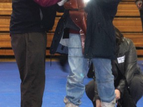 Bill Carter of victim services helps Grade 7 student Shane Newberry suit up for the relay race during VIBE Day at J.R. Robson School this past Thursday.