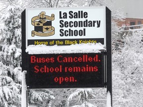 A sign in front of La Salle Secondary School informs passers by that school buses in the Kingston area have been cancelled following a snowfall in November in this Whig-Standard file photo. Despite a seemingly never-ending winter, the frequency of school bus cancellations has not been more than normal, according to the agency that co-ordinates busing for the area's three school boards. (Ian MacAlpine)