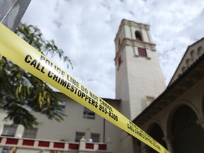 Police tape cordons off an area at Roosevelt High School after a shooting incident in Hawaii January 28, 2014. (REUTERS/Hugh Gentry)
