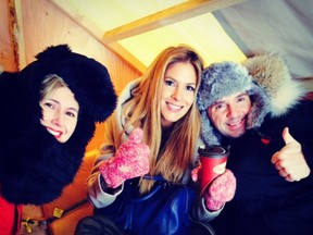 Frank Ferragine tries to stay warm while ice fishing with his friends from Breakfast TV, Jennifer Valentyne, left, and Dina Pugliese.