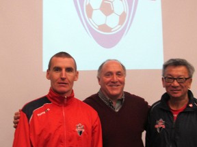Kingston FC head coach Colm Muldoon, left, owner Lorne Abugov, centre, and assistant coach Mike Akai stand beneath an image of the soccer team's new logo at a news conference at Queen's University's Athletics and Recreation Centre Tuesday, Jan. 28. (Patrick Kennedy/The Whig-Standard)