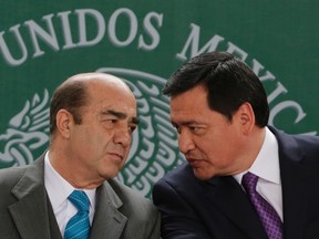 Interior Minister Miguel Angel Osorio Chong (R) talks with Attorney General Jesus Murillo Karam at the launch of an anti-kidnapping unit in Mexico, at the interior ministry in Mexico City January 28, 2014. (REUTERS/Henry Romero)