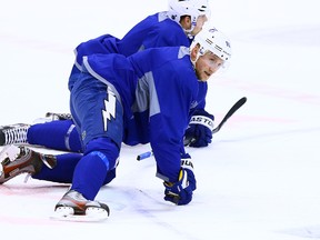 Steven Stamkos of the Tampa Bay Lightning takes part in stretches during Tuesday's morning skate in Toronto. His status with his NHL team and for the Olympics remains up in the air. (DAVE ABEL/TORONTO SUN)