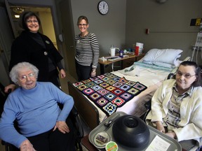 Residents Doris Morris (foreground, left) and Mercia DeVriendt (foreground, right) along with Corrie Fransen, Director Woodingford Lodge Oxford County (rear, left) and Jennifer Healey, Manager Woodingford Lodge Tillsonburg (rear, right) are looking forward to an anticipated mid-March return Woodingford Lodge Tillsonburg. In the meantime, both residents and staff are making the best of temporary accommodations at Tillsonburg District Memorial Hospital (24 of 32 residents); Woodingford Lodge Ingersoll (four residents) and Woodingford Lodge Woodstock (four residents). Jeff Tribe/Tillsonburg News