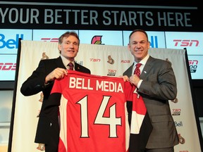 Ottawa Senators President Cyril Leader and Bell Media President Kevin Crull pose with a Sens jersey in Ottawa on Wednesday Jan 29, 2014. Bell Media and the Ottawa Senators announced a 12-year regional broadcast rights and corporate sponsorship agreement. Tony Caldwell/Ottawa Sun/