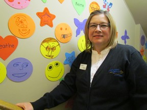 Connie Manning, coordinator of programs for children at St. Joseph's Hospice, stands in a stairway where the walls have been decorated by youngsters in the Caring Hearts programs it offers. Those programs help children and teenagers dealing with the death of a loved one. PAUL MORDEN/THE OBSERVER.QMI AGENCY