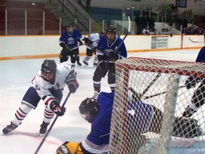 Sam Gerrand (white uniform) wheels behind the net during the second period of provincials action vs. the High Country Rockies. Greg Cowan photo/QMI Agency.