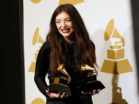 Pop singer Lorde poses backstage with her awards for song of the year for "Royals" and best pop solo performance for "Royals" at the 56th annual Grammy Awards in Los Angeles, California January 26, 2014.     (REUTERS/Danny Moloshok)
