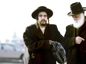 Nachman Helbrans, left, son of Lev Tahor leader Shlomo Helbrans, is shown speaking with another man on the street where a majority of the group settled in Chatham, Ont., Nov. 2013. (DIANA MARTIN/QMI Agency)