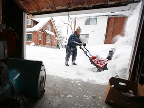 Despite a bad cold and nowhere else to pile up snow around his George Street property, George Skalin keeps blowing the "white stuff" wherever he can Wednesday afternoon, Jan. 29, 2014. -   JEROME LESSARD/The Intelligencer/ QMI Agency