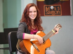 Abigail Kirkton poses with a guitar in the music room at Oakridge secondary school. In addition to acting, Kirkton also sings and plays the guitar.