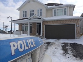 Ottawa Police guard 174 Brambling Way in the city's south end, where a woman was found stabbed to death on Wednesday, Jan. 29, 2014. (TONY CALDWELL Ottawa Sun)