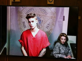 Pop singer Justin Bieber appears via video conference in his first court appearance since being arrested early morning in Miami, Florida January 23, 2014. (REUTERS/Walter Michot/Pool)