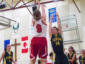 Jayden Kennedy (St. Michaels - white uniform) takes a three-point shot over the outstretched hands of Aislinn Maguire. Greg Cowan photo/QMI Agency.