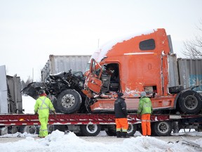 Crews remove one of the transports damaged in Thursday multi-vehicle crash on Hwy. 401 near Napanee.