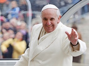 Pope Francis waves as he leaves at the end of his general audience in Saint Peter's Square at the Vatican on January 29, 2014. (REUTERS/Tony Gentile)