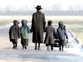 Lev Tahor children are walked home during the lunch hour from the makeshift school they attend in Chatham, On., Friday November 29, 2013. Leaders for the group living in Chatham are planning to fight the Quebec orders to remove 14 children into foster care stating there are concerns the children will be "damaged forever" in foster care. (Diana Martin/QMI Agency)