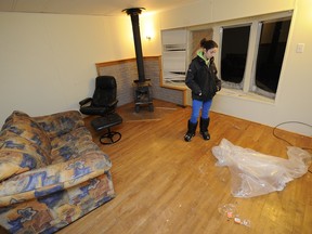 Sarah Montminy in her damaged house on Thursday, Jan. 30, 2014, (DANIEL MALLARD/QMI AGENCY)