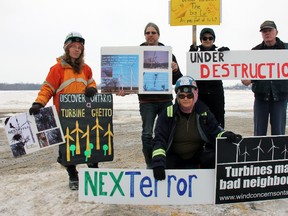 (Back row from left) Esther Wrightman, Dan Wrightman, Cathy McLean, Bill Melick and (front) Muriel Allingham show off signs in protest of the Nextera Adelaide Project and wind turbine construction happening across Ontario at a Middlesex Lambton Wind Action Group protest beginning in Parkhill Jan. 31. About 15 vehicles – many carrying signs and messages of their disapproval -  convoyed through parts of the area that energy giant Nextera has earmarked for wind turbine construction.
JACOB ROBINSON/AGE DISPATCH/QMI AGENCY