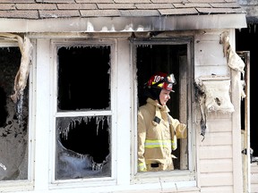 Kingston Fire and Rescue Inspector Tracey LeBlanc enters a  home on Connaught Street in Kingston on Thursday after it was destroyed in an overnight fire.  
IAN MACALPINE/KINGSTON WHIG-STANDARD/QMI AGENCY