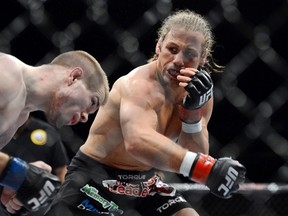 Urijah Faber (red gloves) fights Michael McDonald (blue gloves) during the bantamweight bout of the UFC on FOX 9 at Sleep Train Arena on December 14, 2013 in Sacramento, CA, USA. (Kyle Terada/USA TODAY Sports)