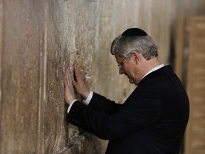 Canada's Prime Minister Stephen Harper touches the stones of the Western Wall, Judaism's holiest prayer site, during a visit to Jerusalem's Old City on Jan. 21.
 REUTERS/Ammar Awad