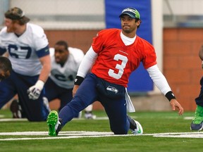 Seahawks QB Russell Wilson stretches at their practice ahead of the Super Bowl in East Rutherford, N.J., on Friday, Jan. 31, 2014. (Shannon Stapleton/Reuters)