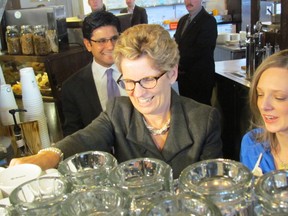 Premier Kathleen Wynne prepares tea for Labour Minister Yasir Naqvi at The Coffee Pubon Bathurst Street in Toronto in this file photo. Wynne announced that the province's minimum wage will rise to $11 from $10.25 an hour as of June 1 2014. 
Antonella Artuso / QMI Agency