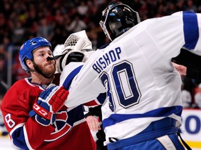 Montreal Canadiens winger Brandon Prust and Tampa Bay Lightning goalie Ben Bishop mix it up during a TV timeout at the Bell Centre in Montreal, Feb. 1, 2014. (RICHARD WOLOWICZ/Getty Images/AFP)