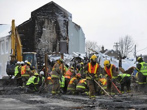 Crews sift through the remains of the seniors' home in Isle-Verte, Que., Jan. 28, 2014. (QMI Agency)