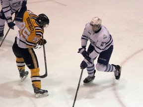 Sarnia native Nick Zottl (right), a defenceman for the Mississauga Steelheads, breaks up an attempted rush by Sarnia Sting forward Nikita Korostelev in the 2nd period of their game on Saturday night. Zottl scored the Steelheads' second goal in a 7-3 Mississauga victory. SHAUN BISSON/THE OBSERVER/QMI AGENCY